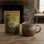 Irish Cream hot chocolate package and steaming mug on a wooden table with a fireplace background